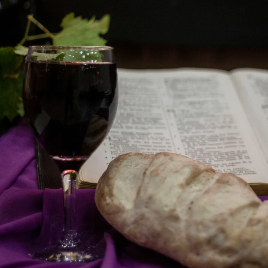 An open Bible with a Communion set, representing biblical guidance on Holy Communion.