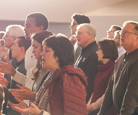 A congregation praying during Holy Communion, highlighting its role in spiritual growth and unity among believers.